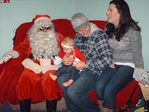 A family sitting with Blind Santa